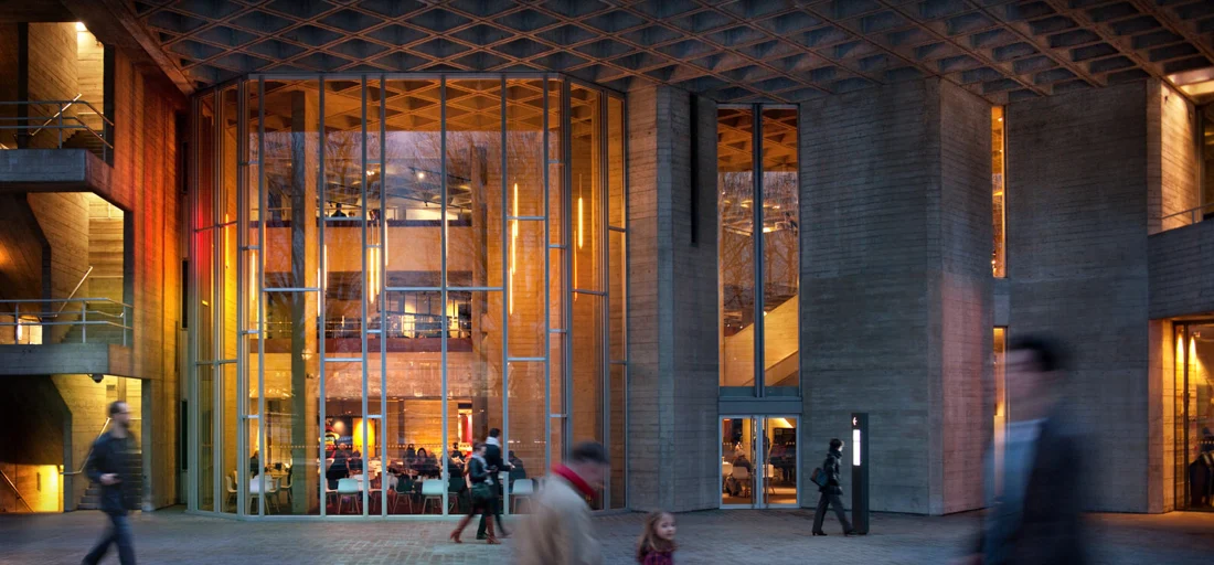 The illuminated entrance and foyer of the National Theatre on London’s South Bank.